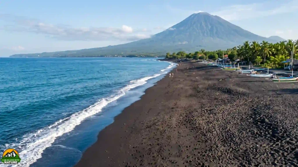 Ultimate Bali Travel Guide 6 Black-sand beach in Amed with fishing boats and Mount Agung rising behind the northeast Bali coast